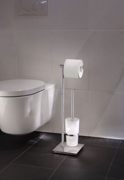 Smedbo Outline Lite FK603 Polished Steel Toilet Butler in Use — Square Base on Dark Slate Floor Tiles Beside Wall-Hung Toilet, Toilet Roll Loaded and Frosted Glass Brush Container Visible
