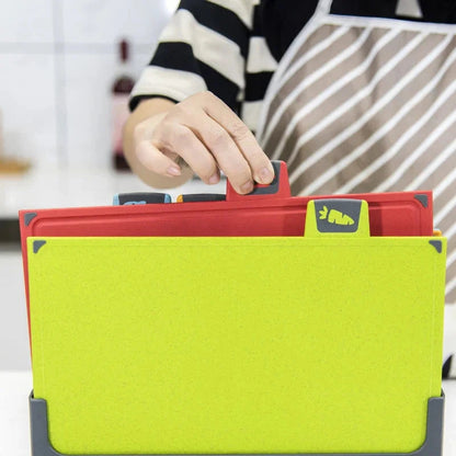 Person pulling out a red chopping board from a set of multi-coloured boards