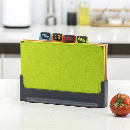 Green cutting board with colourful labels on a kitchen counter