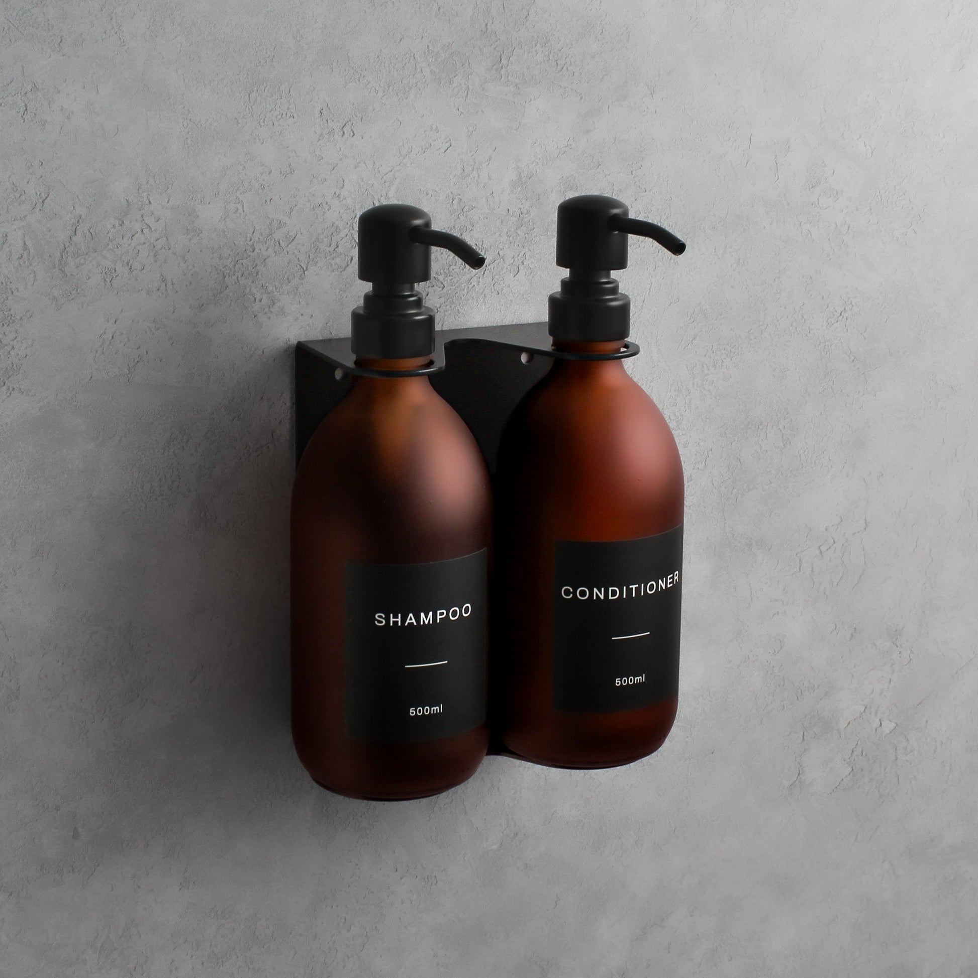 Namie Matte Black Wall Mounted Dispenser Bracket Set with Frosted Amber Glass Bottles