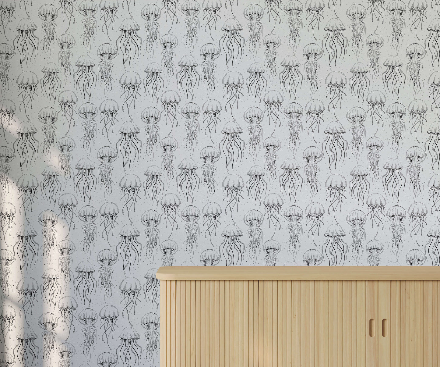 Wallpaper with jellyfish pattern on a light gray background, featuring a wooden cabinet.