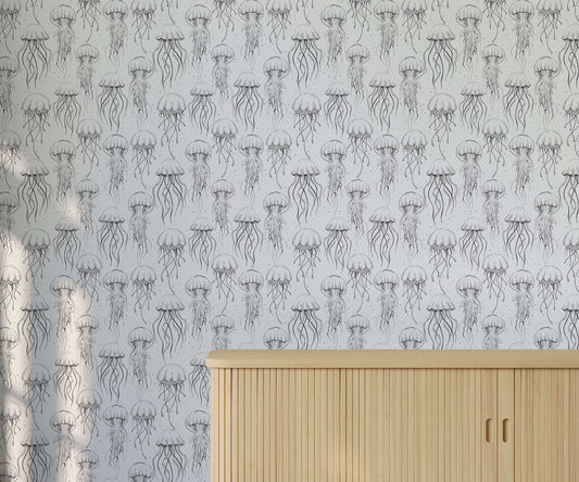Wallpaper with jellyfish pattern on a light gray background, featuring a wooden cabinet.