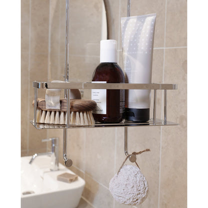 Smedbo Sideline DK3041 Lower Basket Tier Close-Up — Shampoo, Scandinavisk Body Lotion, Wooden Brushes and Natural Loofah on Lower Hook, Beige Tiled Bathroom