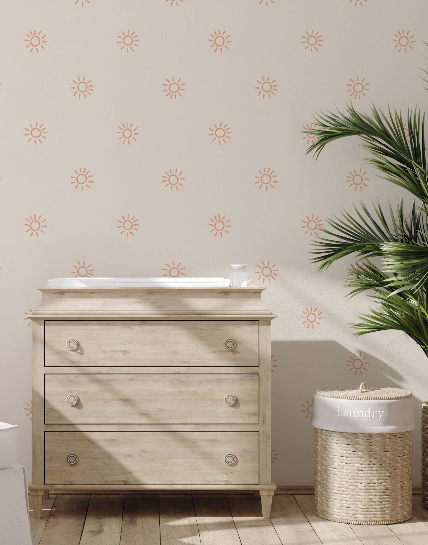 Wooden dresser with a white countertop against a wall with sun pattern