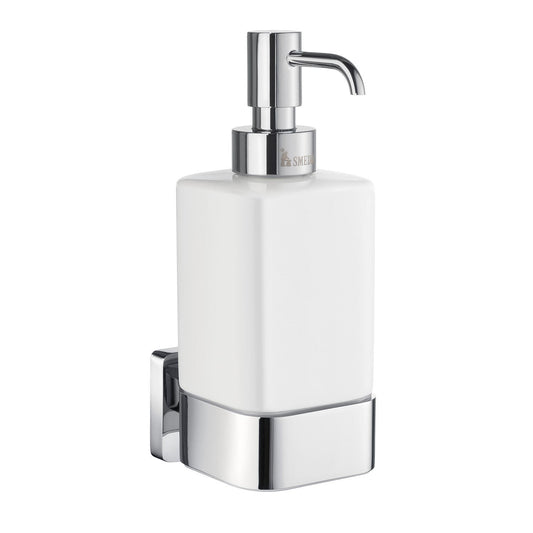 Wall-mounted soap dispenser with white container and chrome pump on a white background