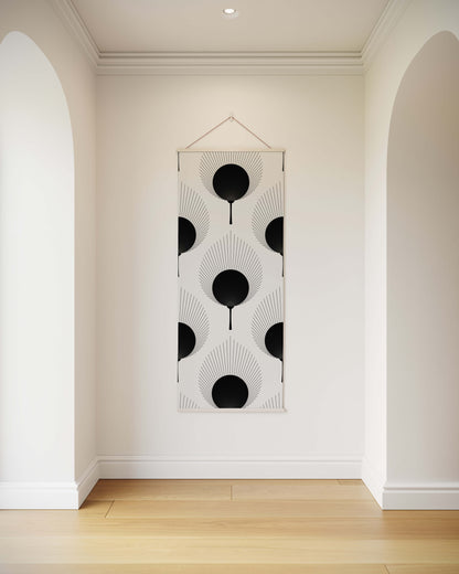 Decorative wall hanging with black and white pattern in a minimalistic room.