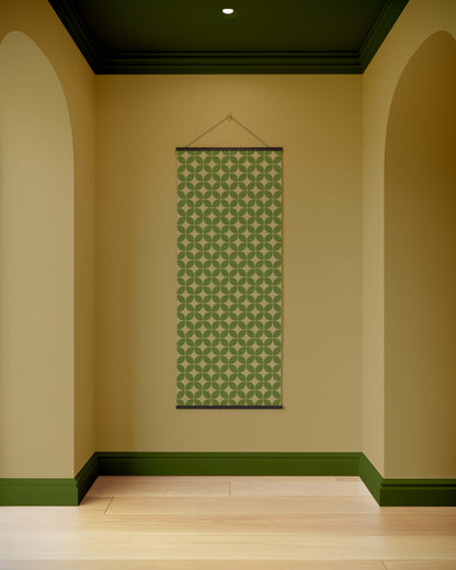 Green patterned tapestry hanging on a beige wall with green trim.