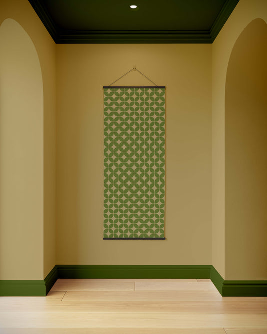 Green patterned tapestry hanging on a beige wall with green trim.