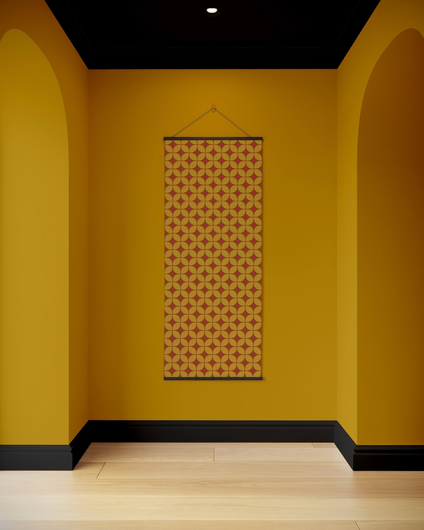 Patterned tapestry hanging on a yellow wall with arches and a black ceiling.