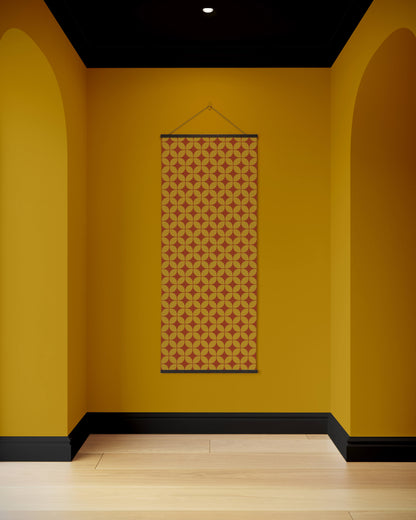Patterned tapestry hanging on a yellow wall with arches and a black ceiling.