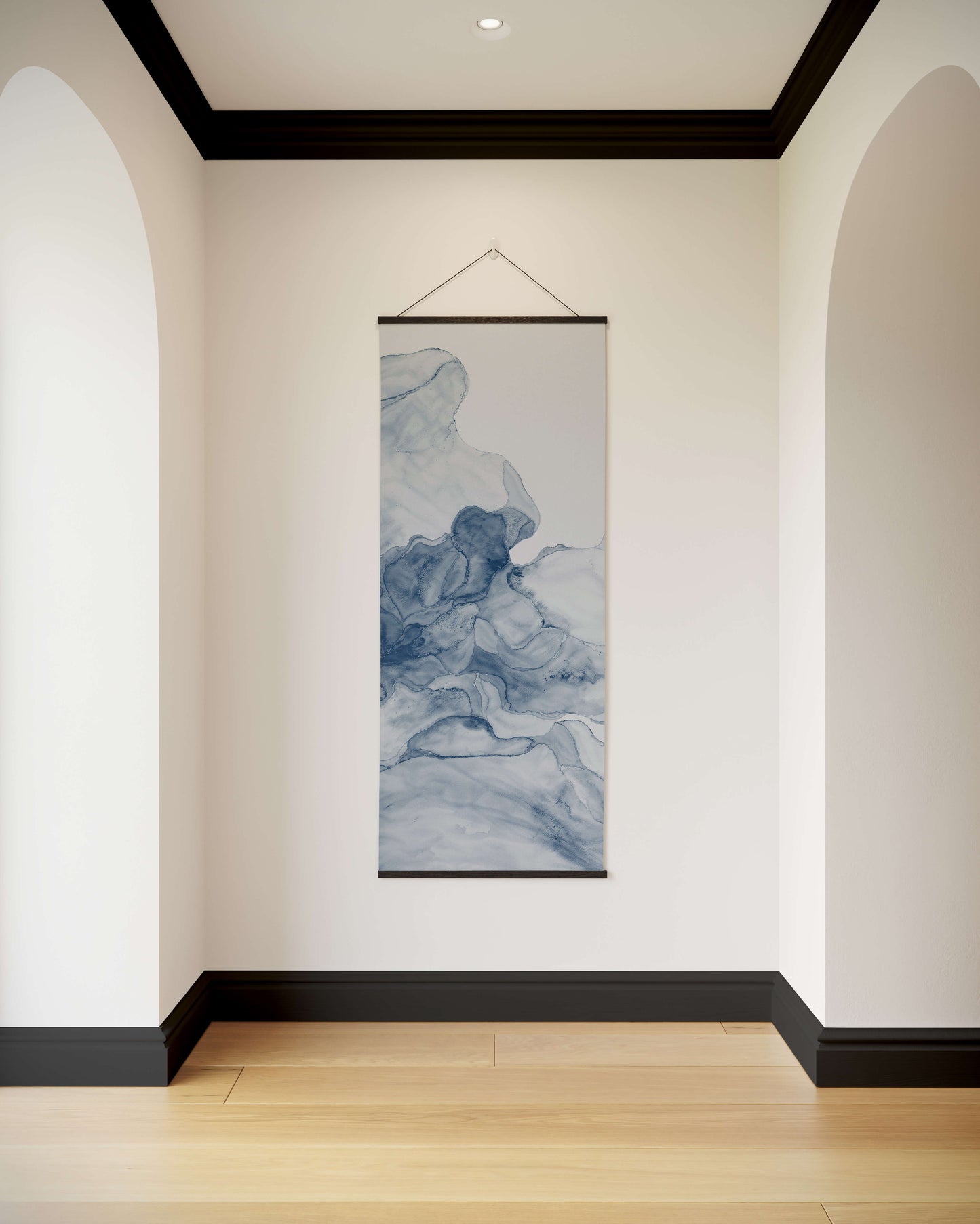 Wall art hanging in a room with white walls and wooden flooring