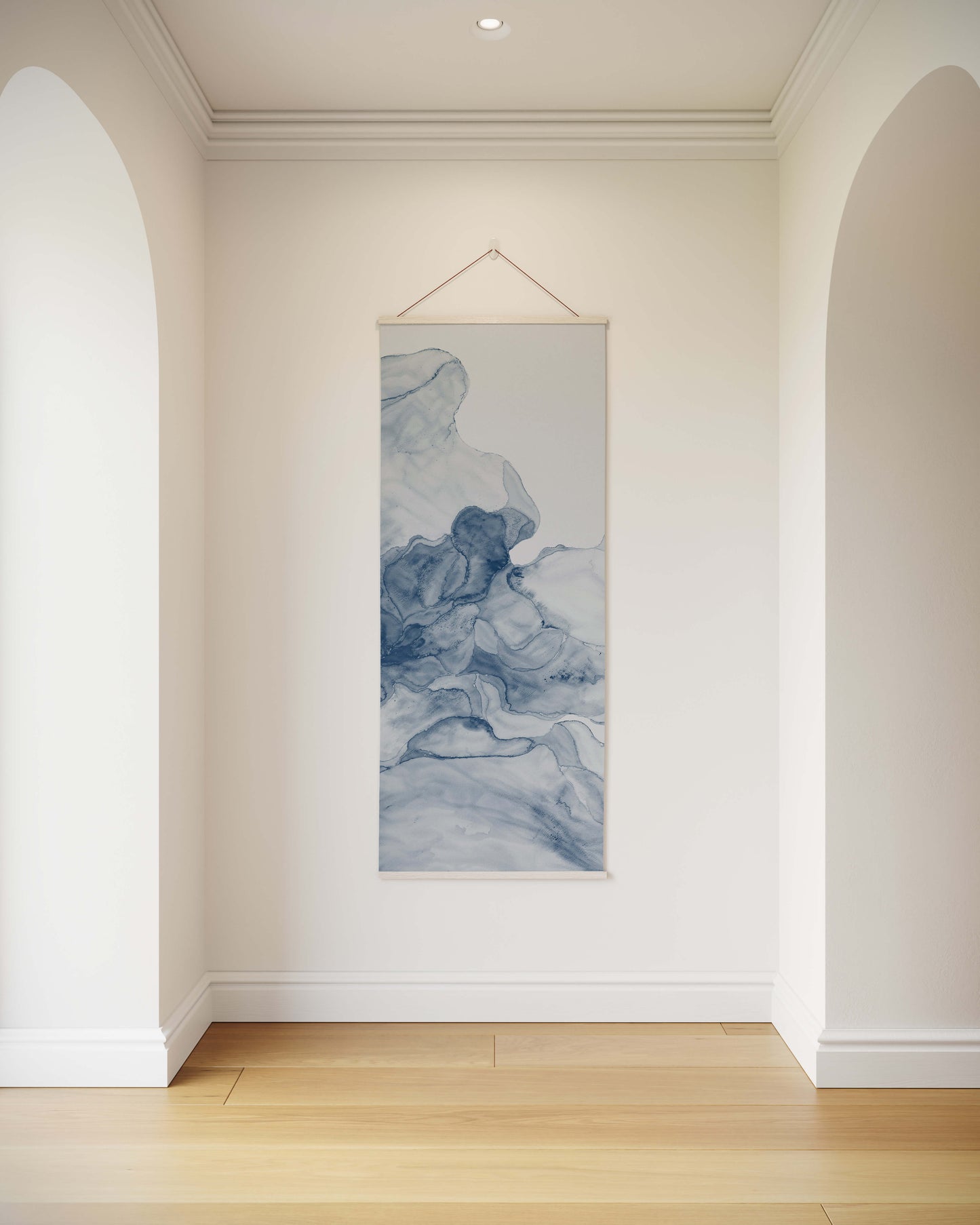 Tapestry hanging on a wall in a room with white walls and wooden flooring