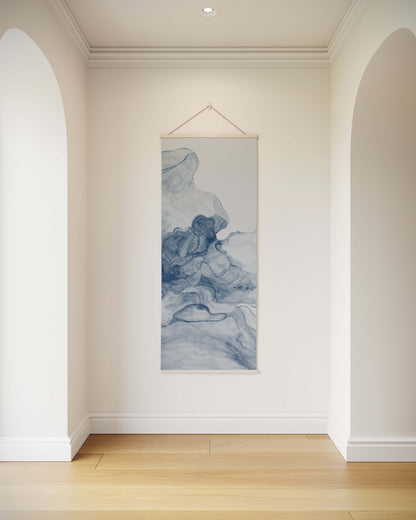 Tapestry hanging on a wall in a room with white walls and wooden flooring