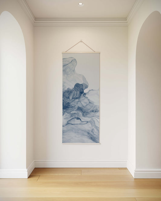 Tapestry hanging on a wall in a room with white walls and wooden flooring