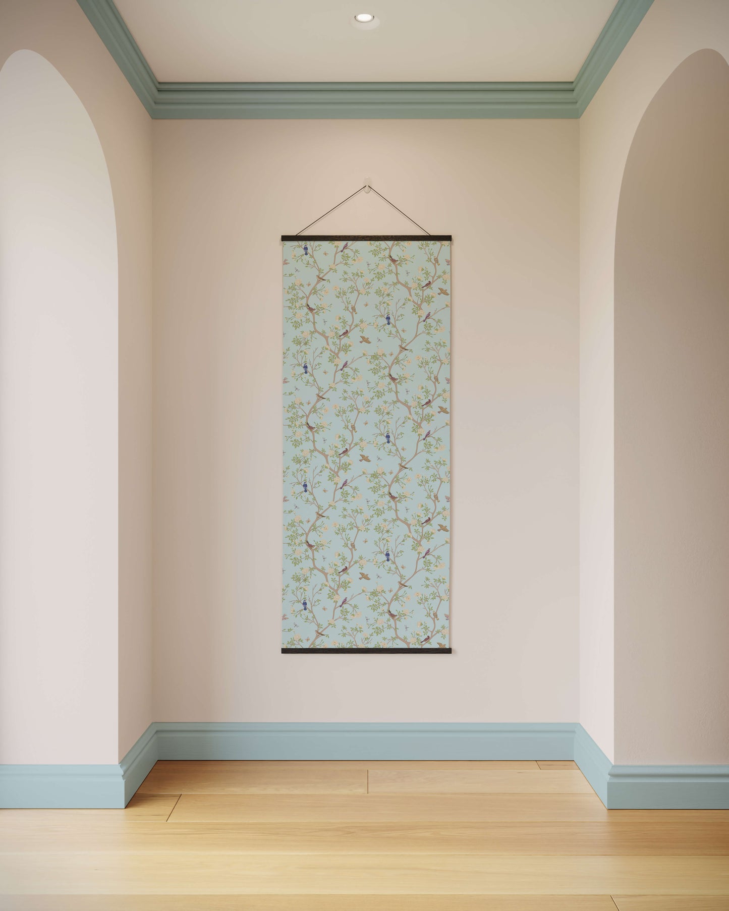 Floral patterned scroll hanging on a wall with light pink walls and blue trim.