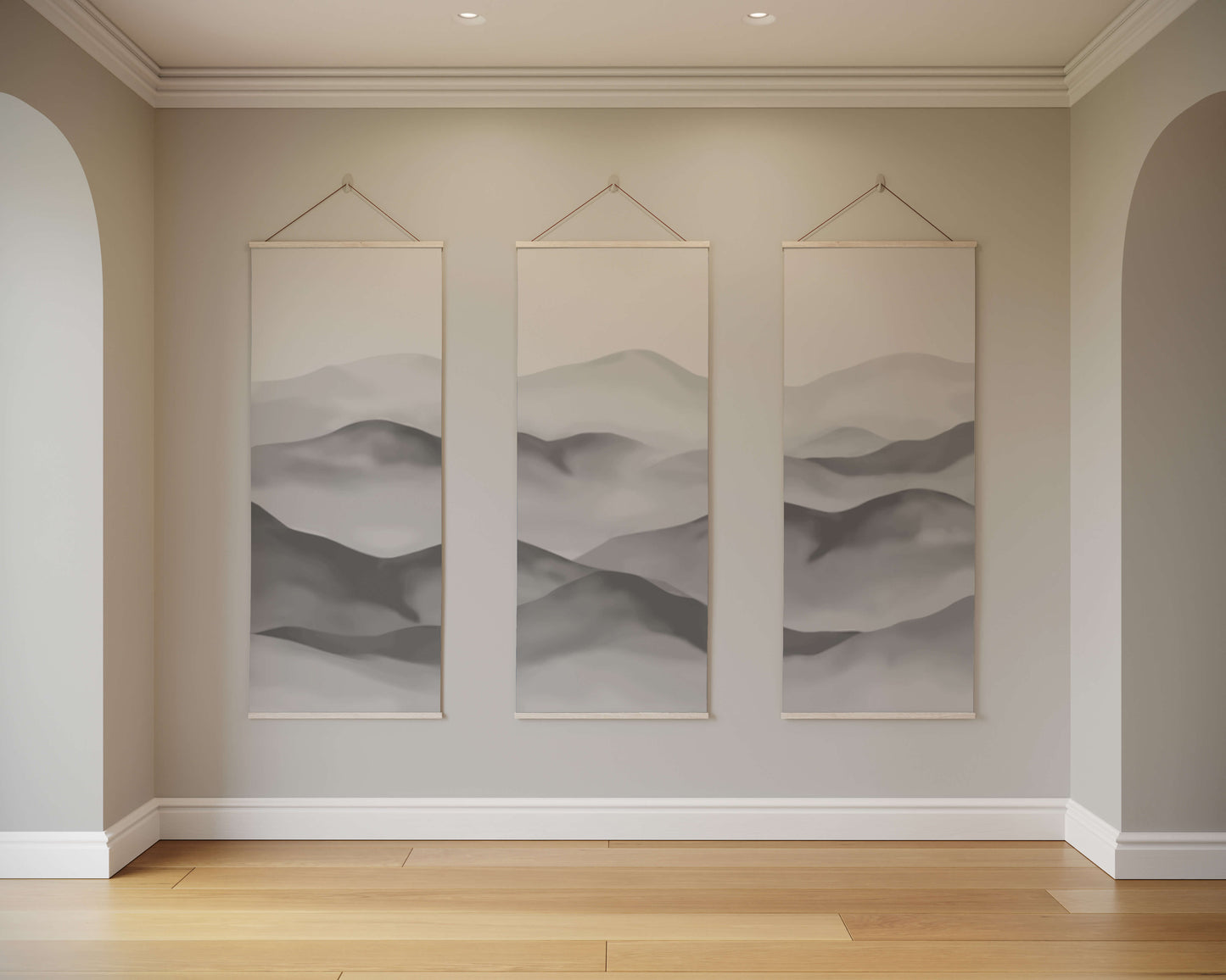 Three framed abstract landscape artworks on a wall with wooden flooring.