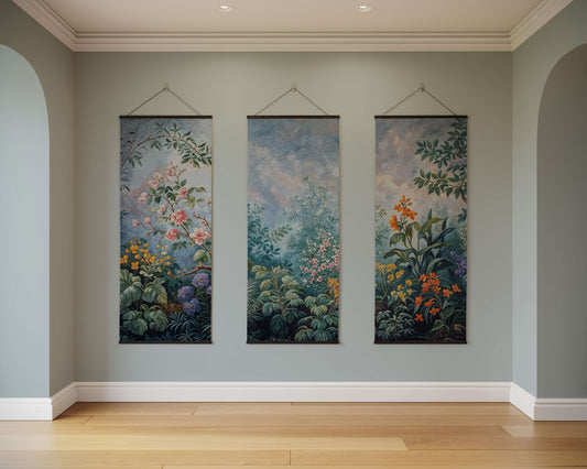 Three floral tapestries hanging on a wall in a room with wooden flooring.