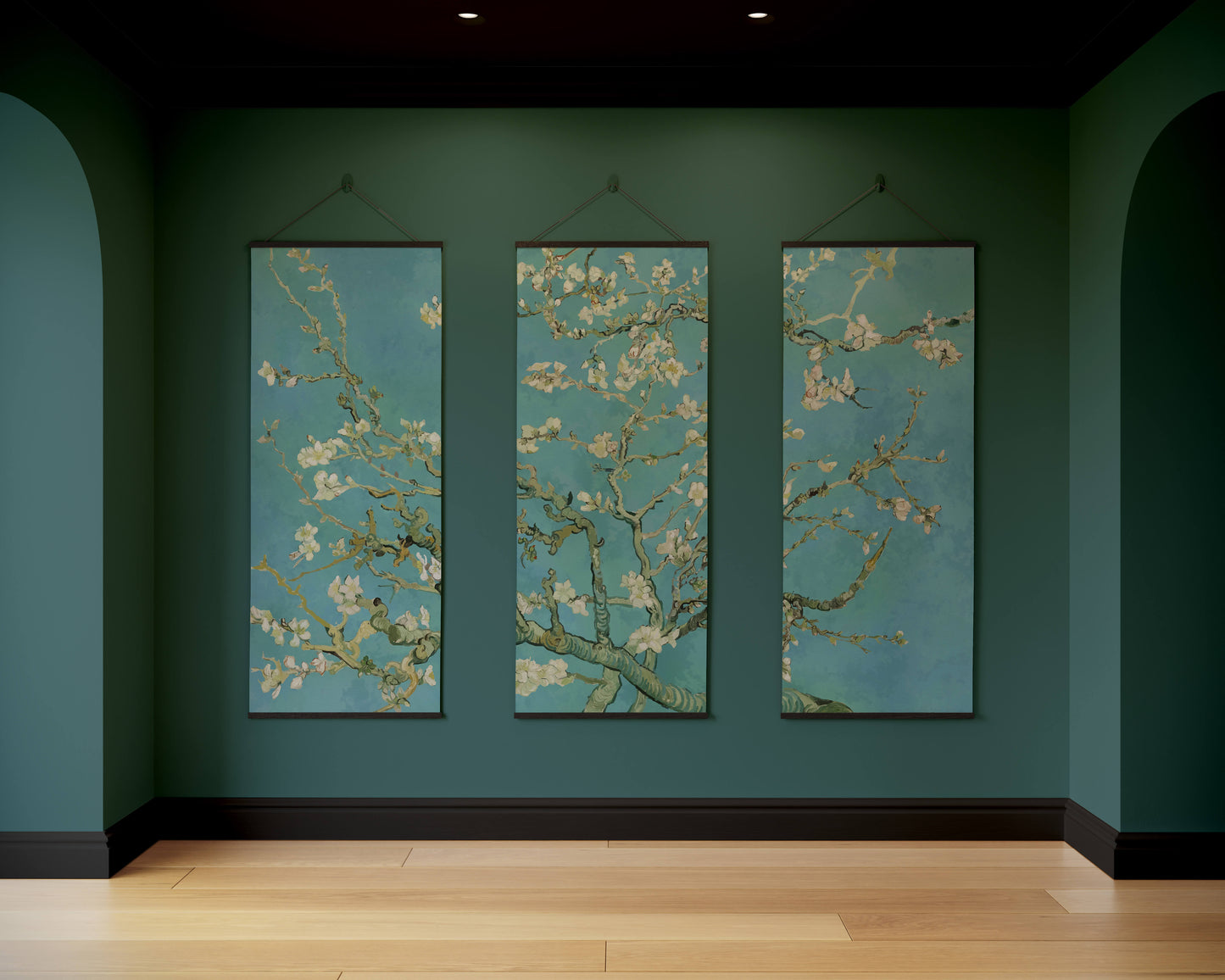 Three vertical artworks of floral branches on a teal wall.