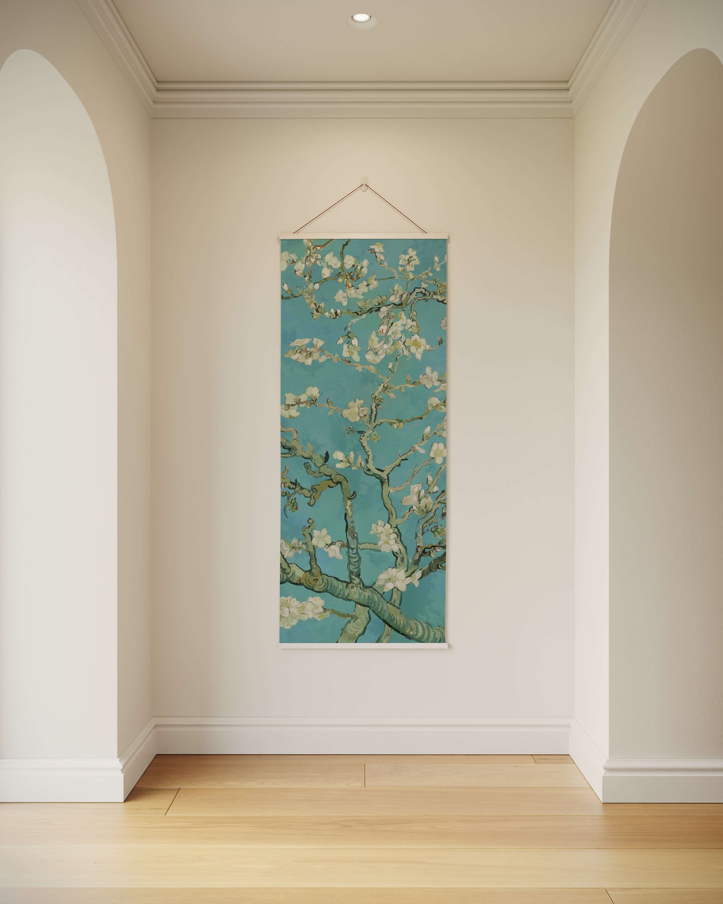 Van Gogh painting of almond blossoms hanging on a wall in a room with wooden floor.