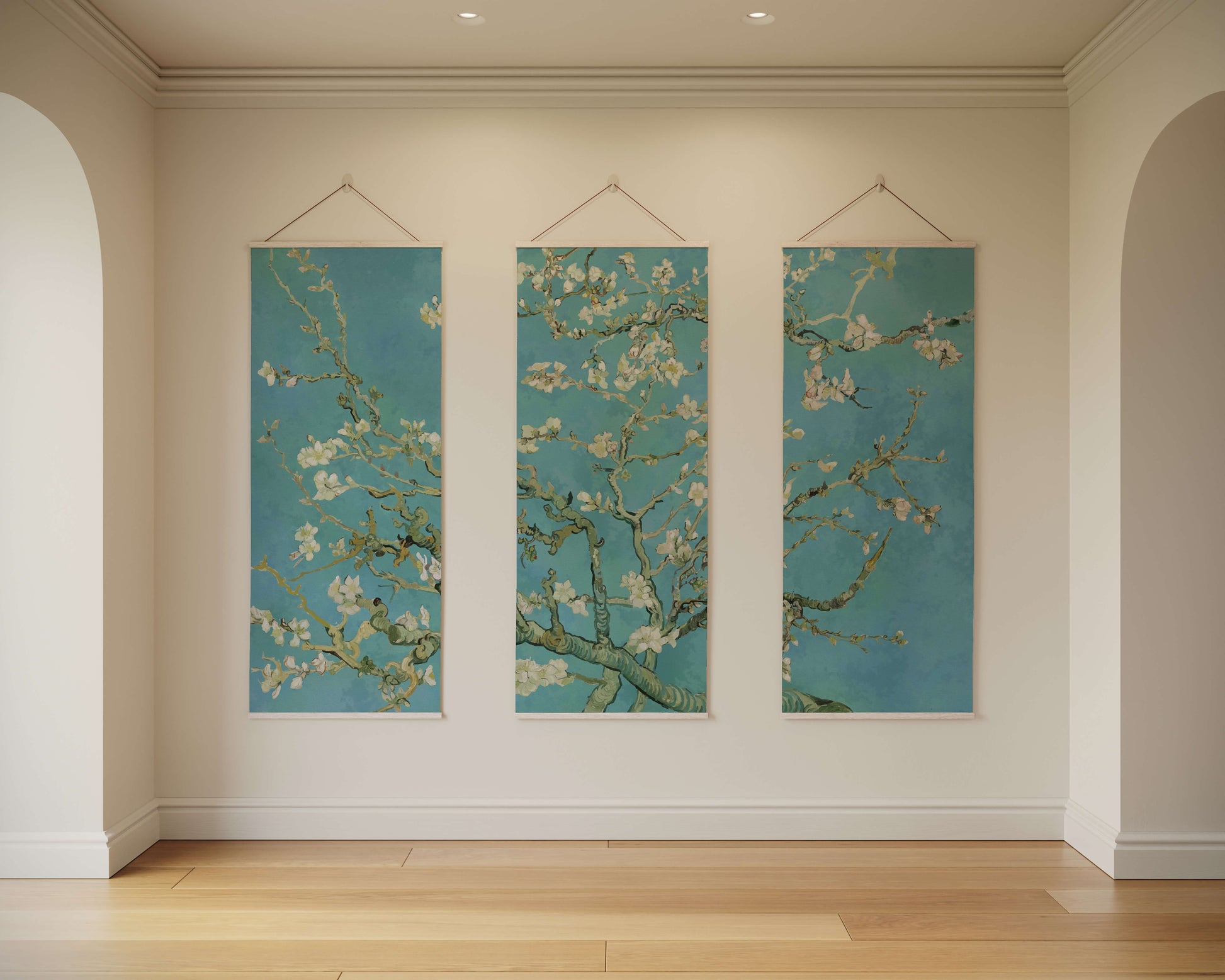 Three vertical artworks hanging on a wall with a light-coloured floor and wall.