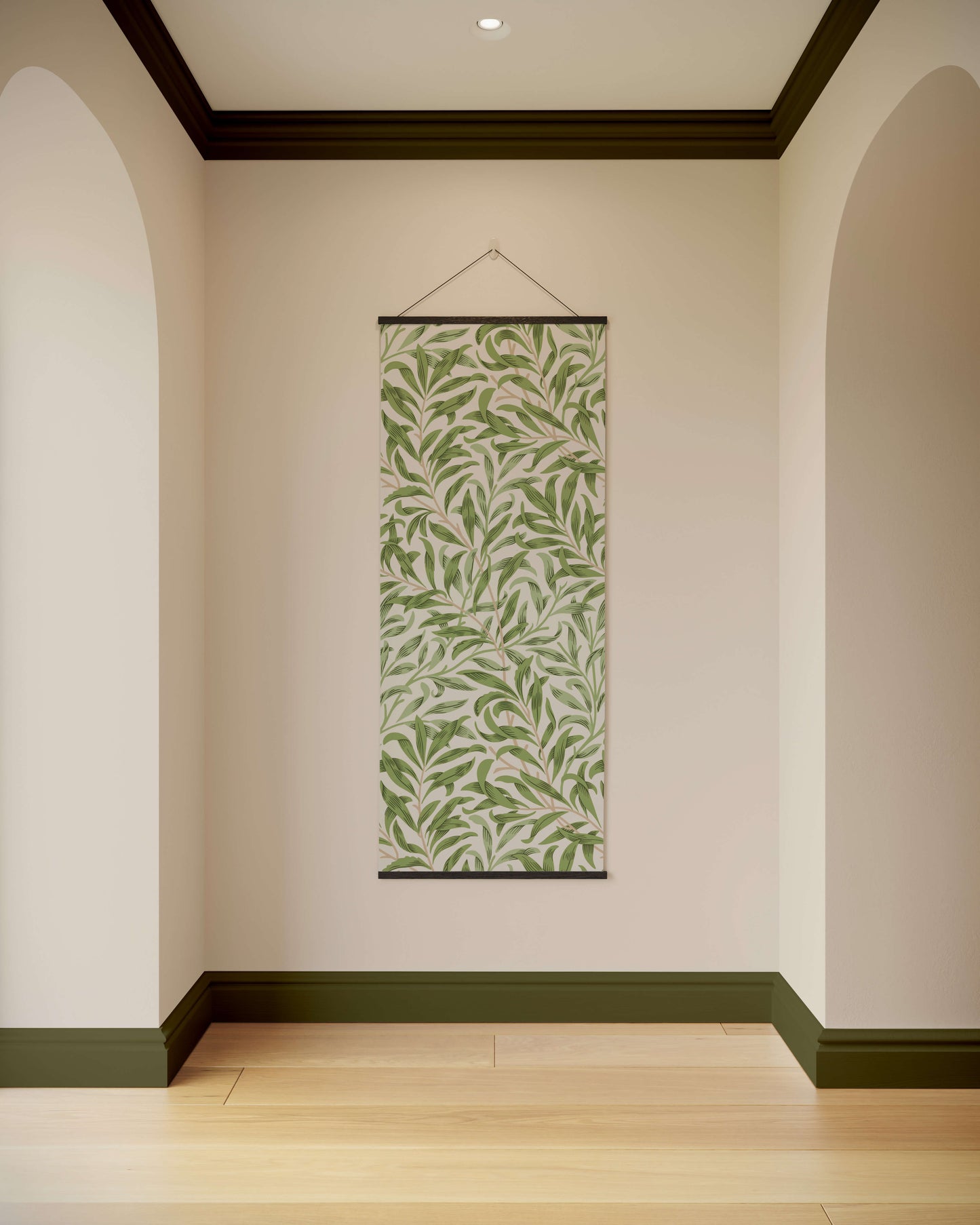 Wall tapestry with green leaf pattern hanging on a plain wall.