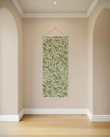 Green leaf-patterned wall hanging on a beige wall with wooden floor.