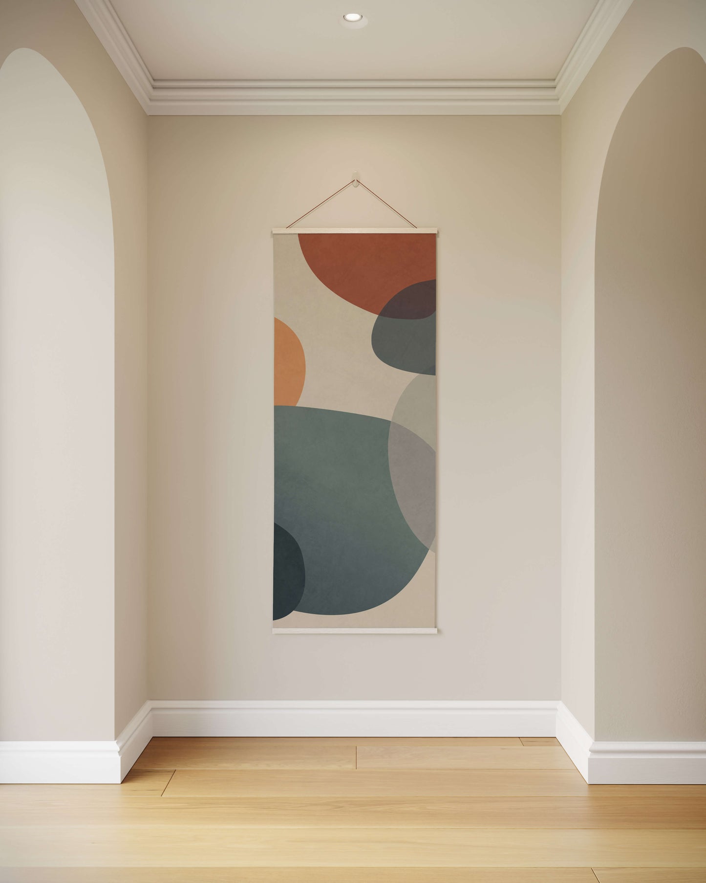 Abstract wall art with colourful circles on a beige wall in a room with wooden flooring.
