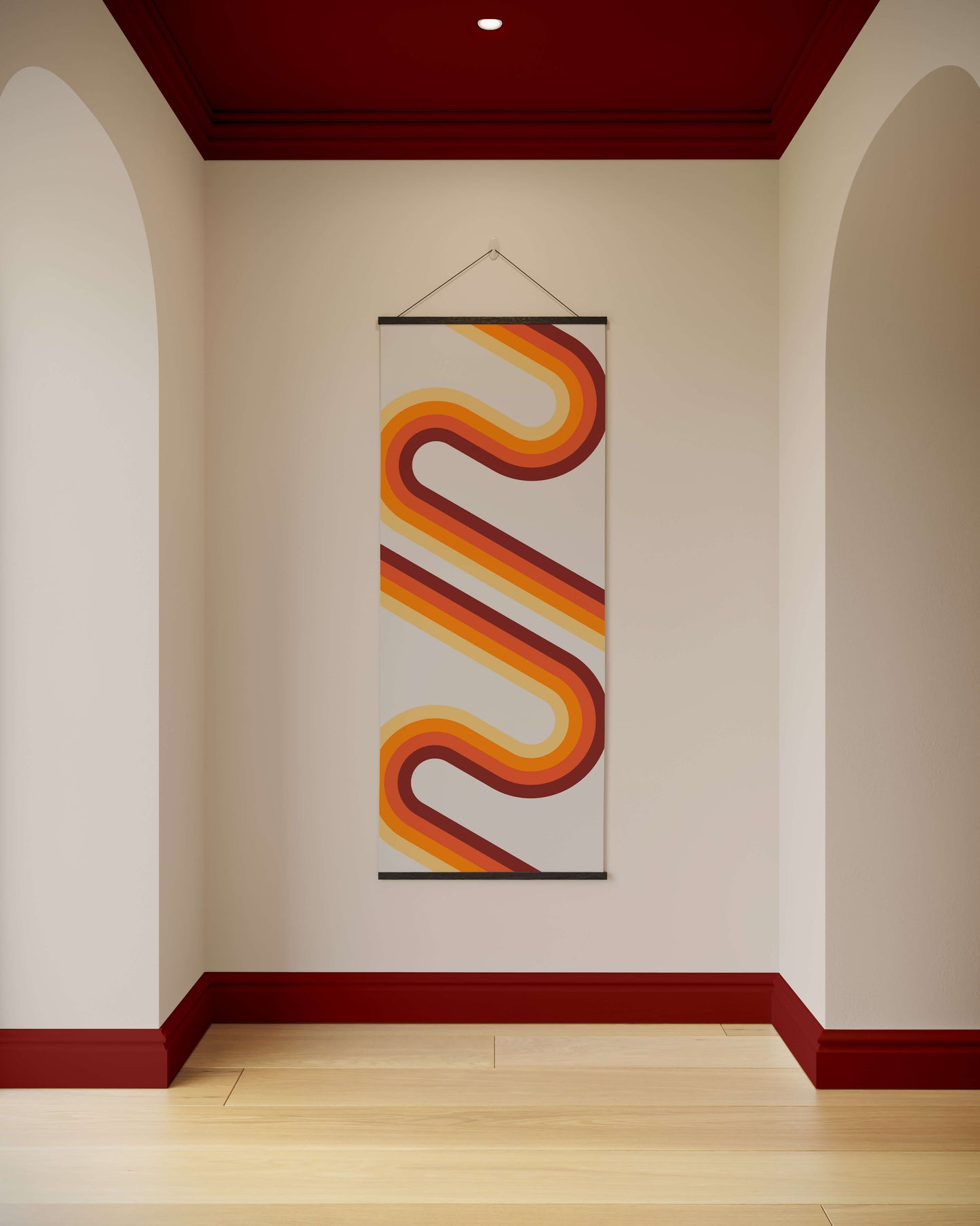 Decorative wall hanging with wavy design on a plain wall.