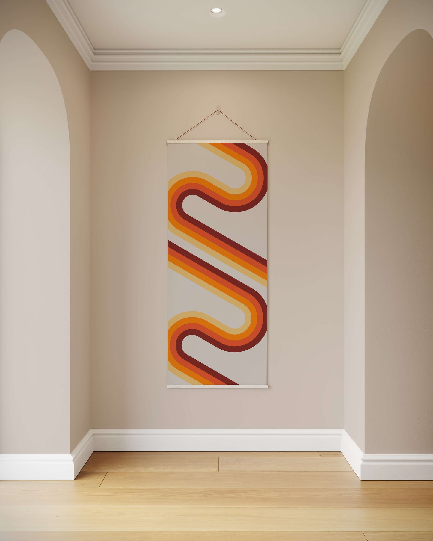Decorative wall hanging with wavy orange and red design on a beige wall.