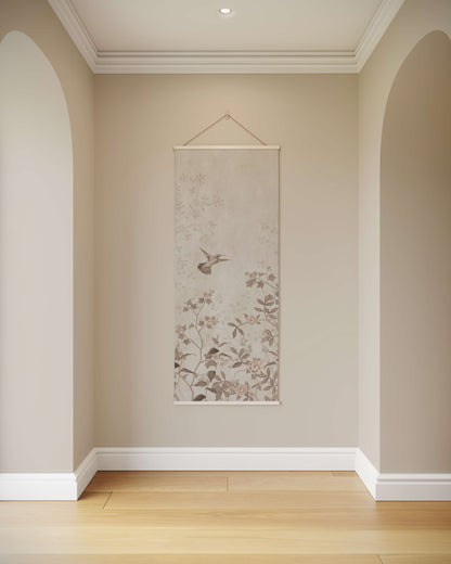 Floral scroll wall art hanging on a beige wall with wooden flooring.
