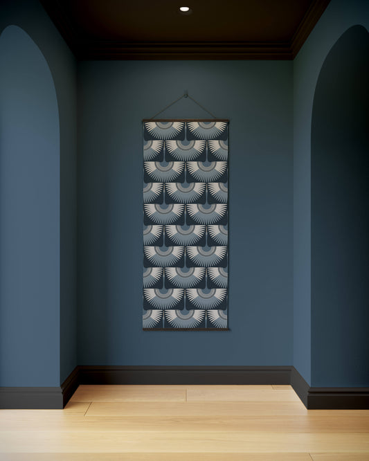 Decorative wall hanging with geometric pattern on a blue wall.