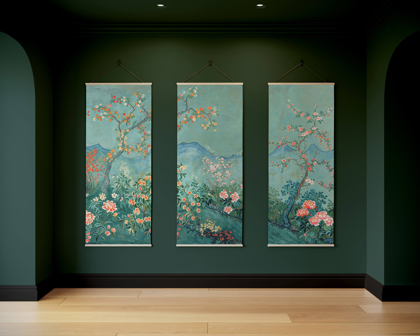 Three vertical floral artworks hanging on a dark green wall.