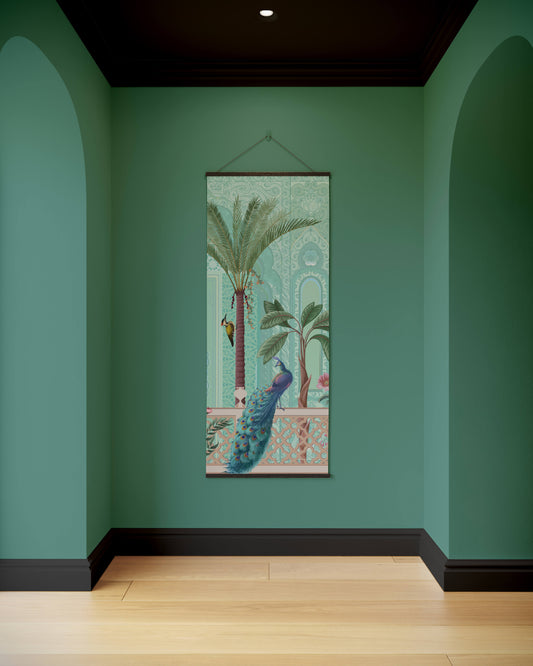 Decorative wall hanging with a peacock and palm tree design on a teal wall.