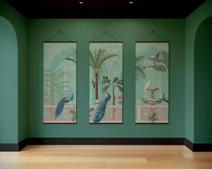 Three decorative wall hangings on a green wall with wooden floor.