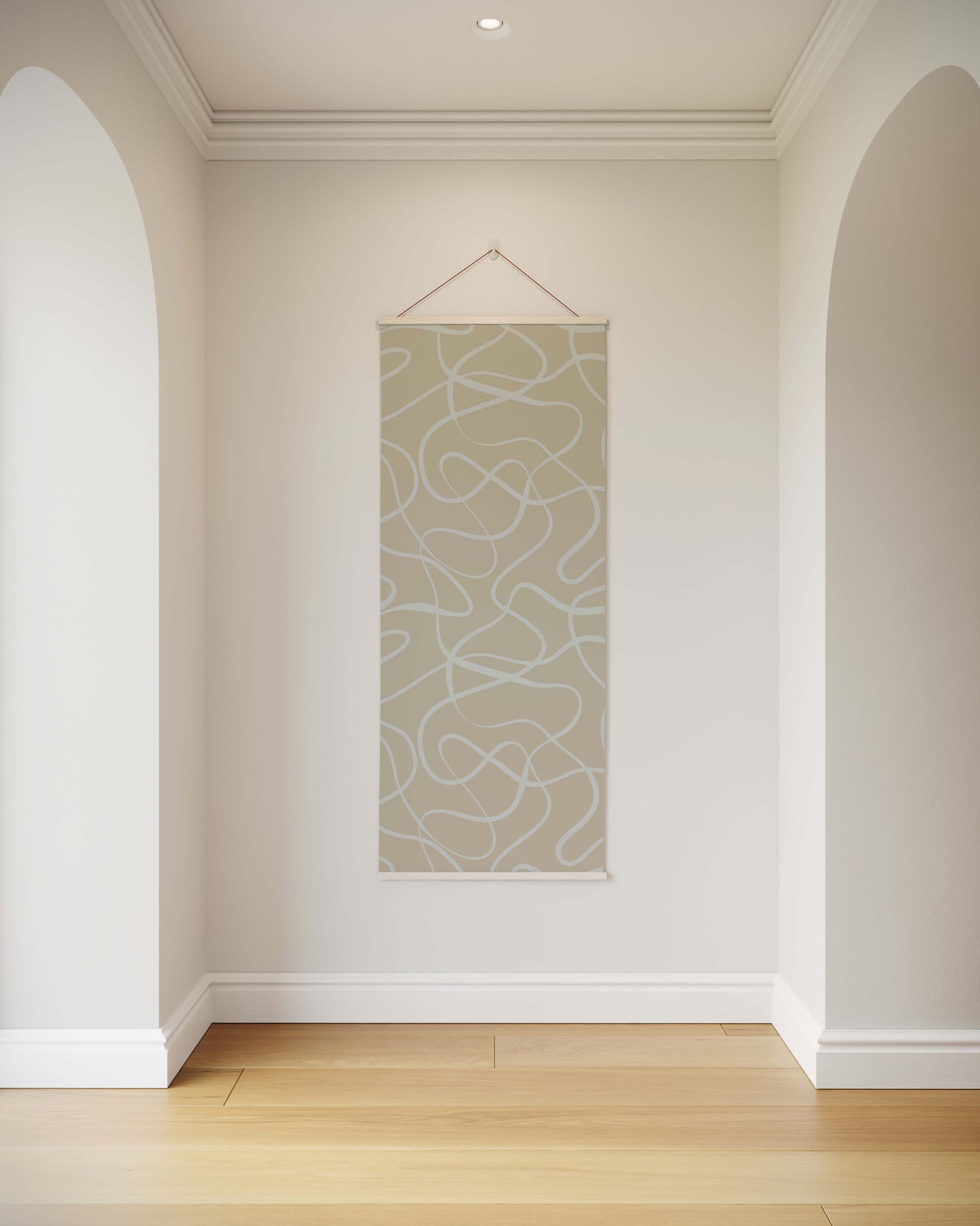 Abstract wall art hanging on a white wall in a room with wooden flooring.