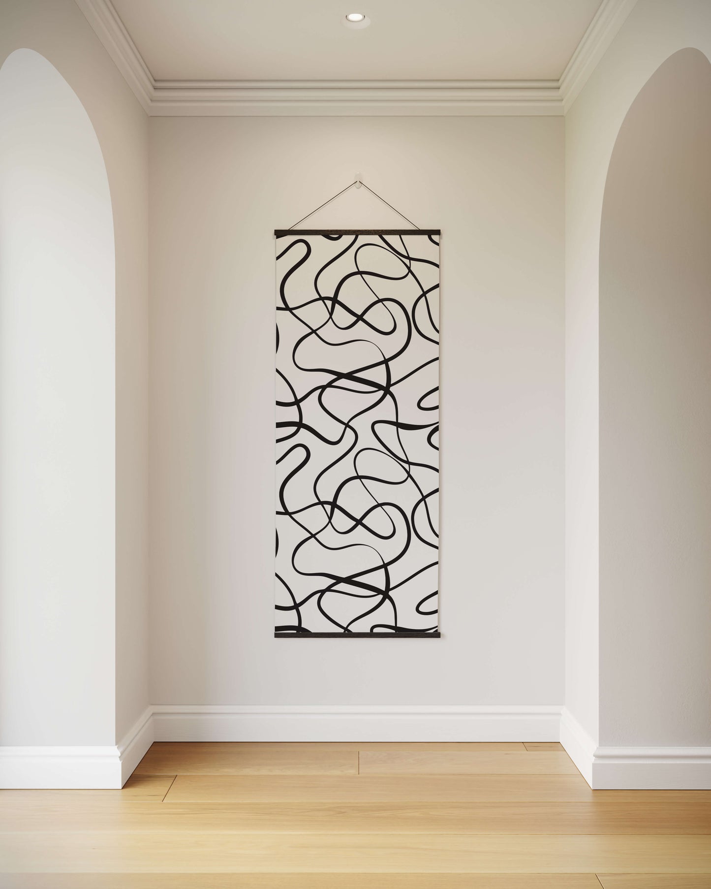 Abstract wall art hanging on a white wall in a room with wooden flooring.