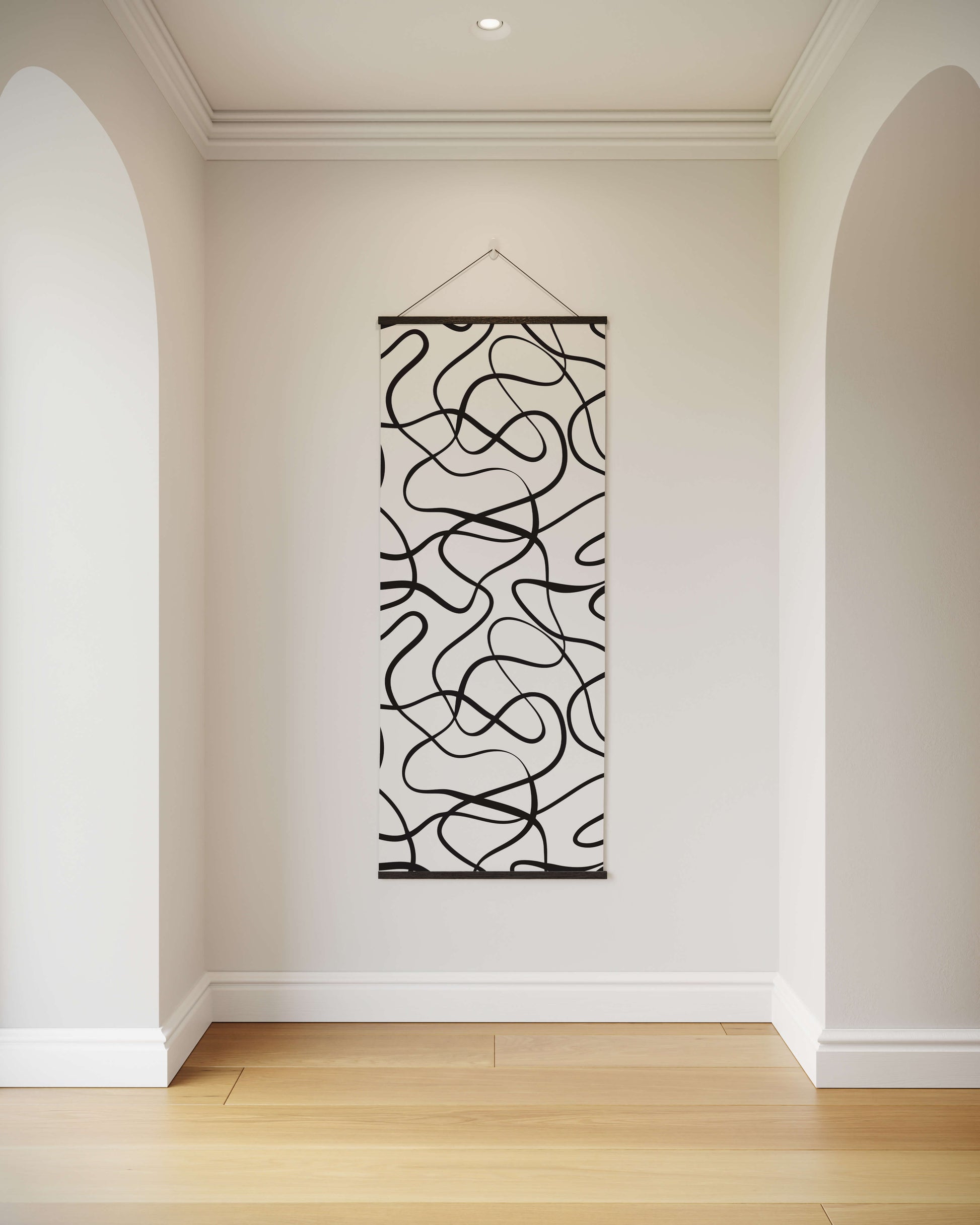 Abstract wall art hanging on a white wall in a room with wooden flooring.