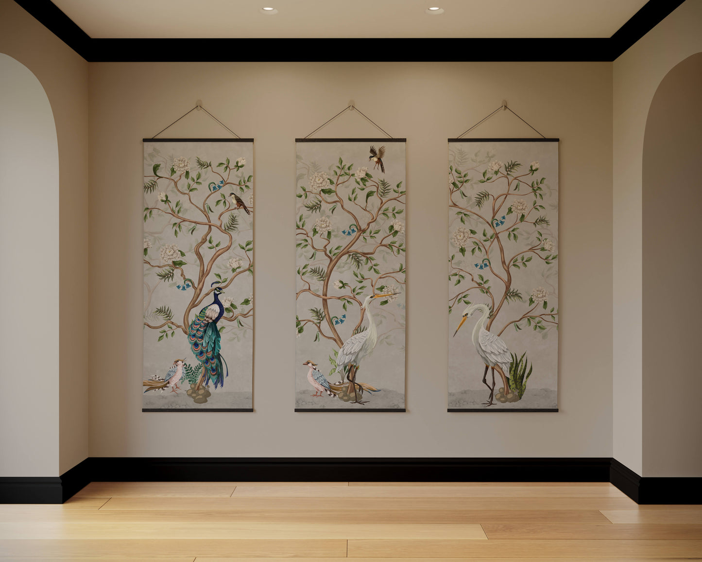 Three hanging wall art pieces with nature-themed designs on a beige wall.