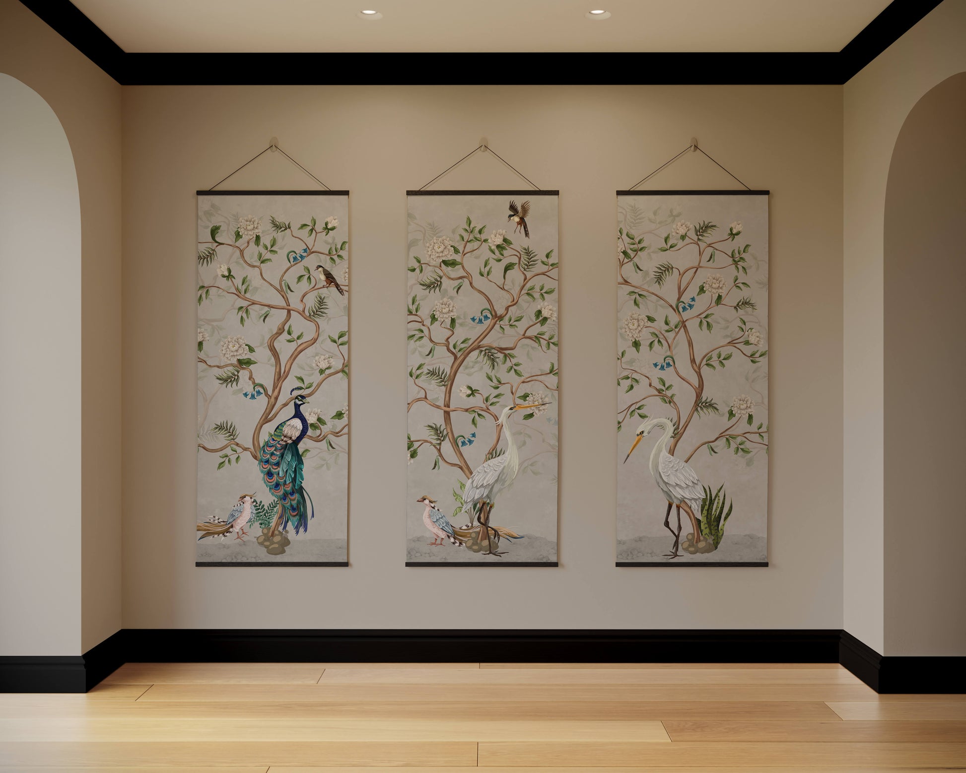 Three hanging wall art pieces with nature-themed designs on a beige wall.