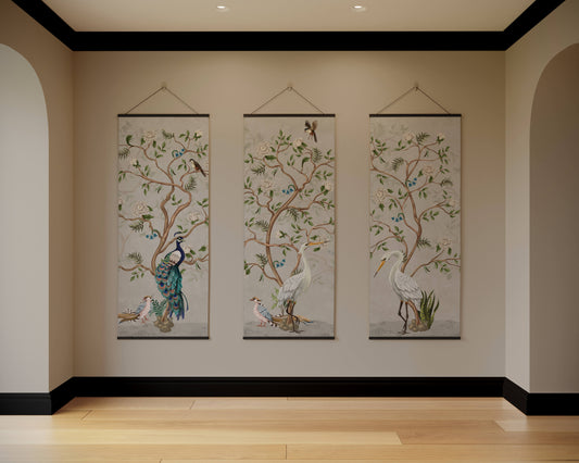 Three hanging wall art pieces with nature-themed designs on a beige wall.