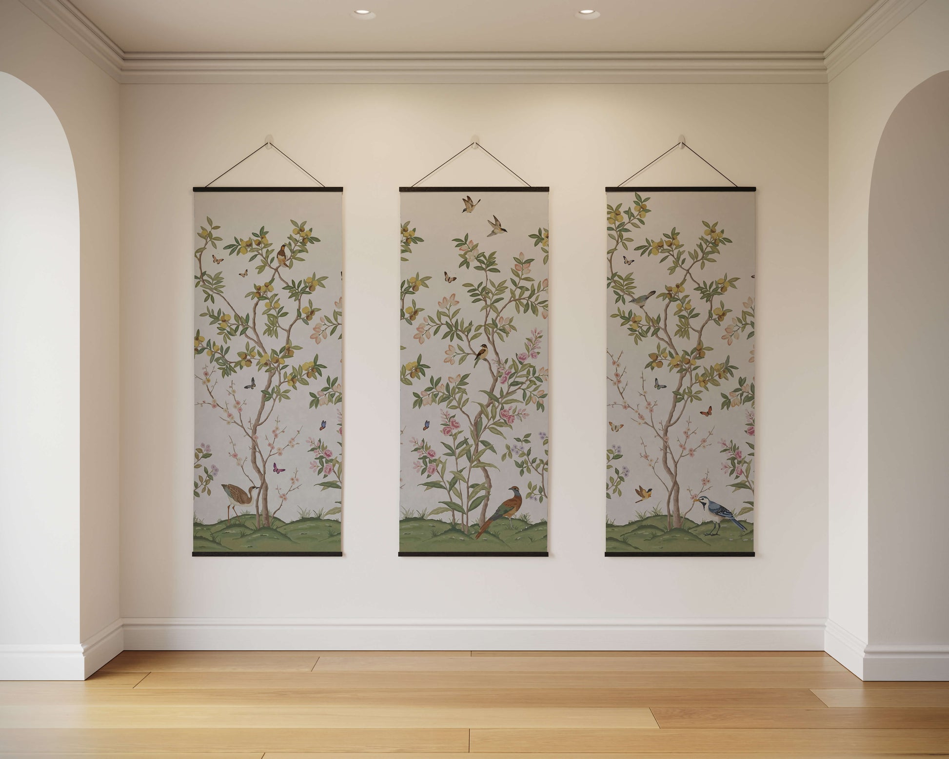 Three vertical wall hangings with nature-themed designs on a white wall.