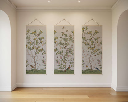 Three vertical wall hangings with floral and bird designs on a plain wall.
