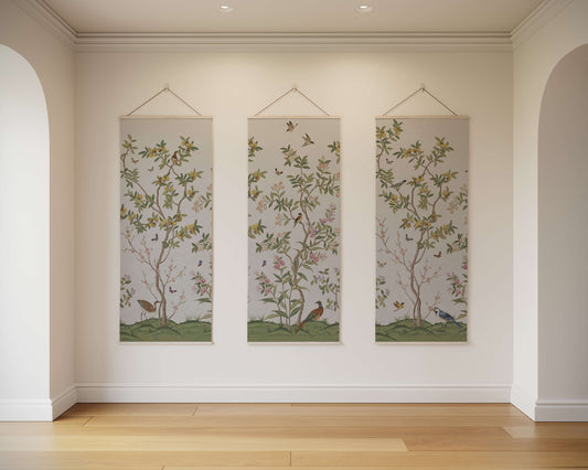 Three vertical wall hangings with floral and bird designs on a plain wall.