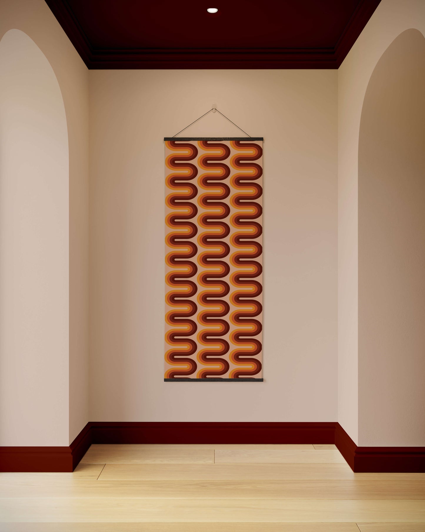 Decorative wall hanging with wavy pattern on a plain wall.