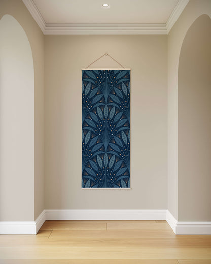 Decorative wall hanging with blue leaf pattern on a beige wall.