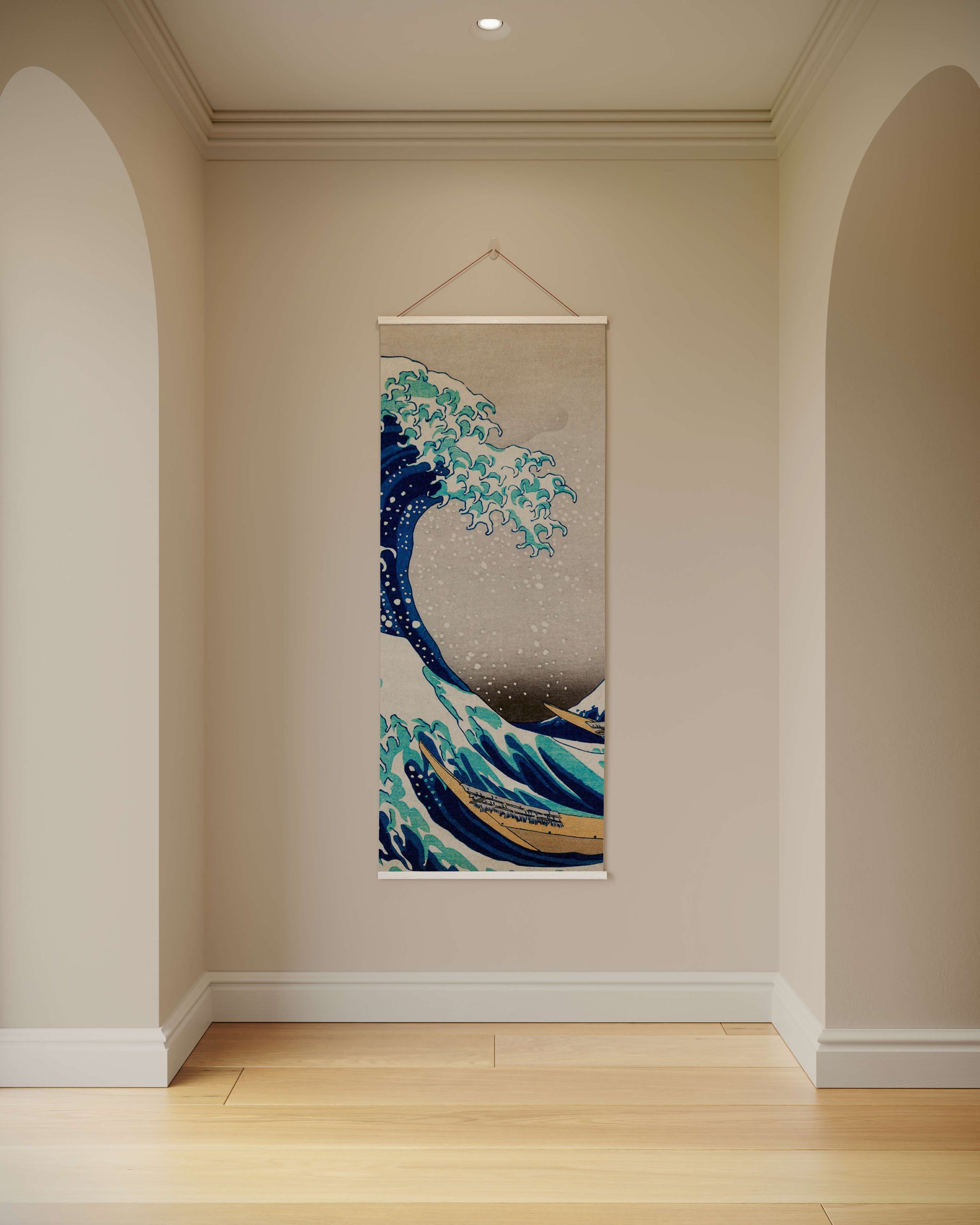 Wall tapestry of a wave design hanging on a wall in a room with wooden flooring.