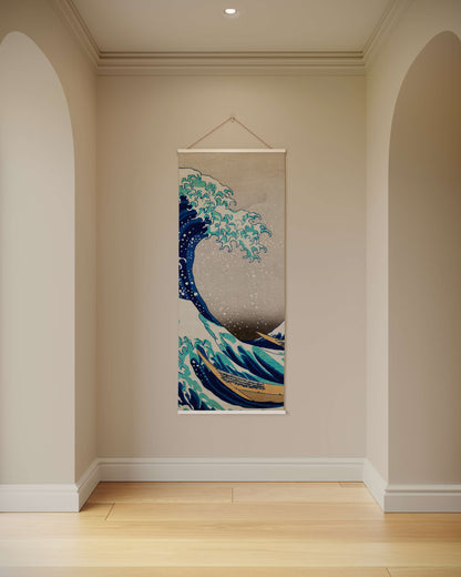 Wall tapestry of a wave design hanging on a wall in a room with wooden flooring.