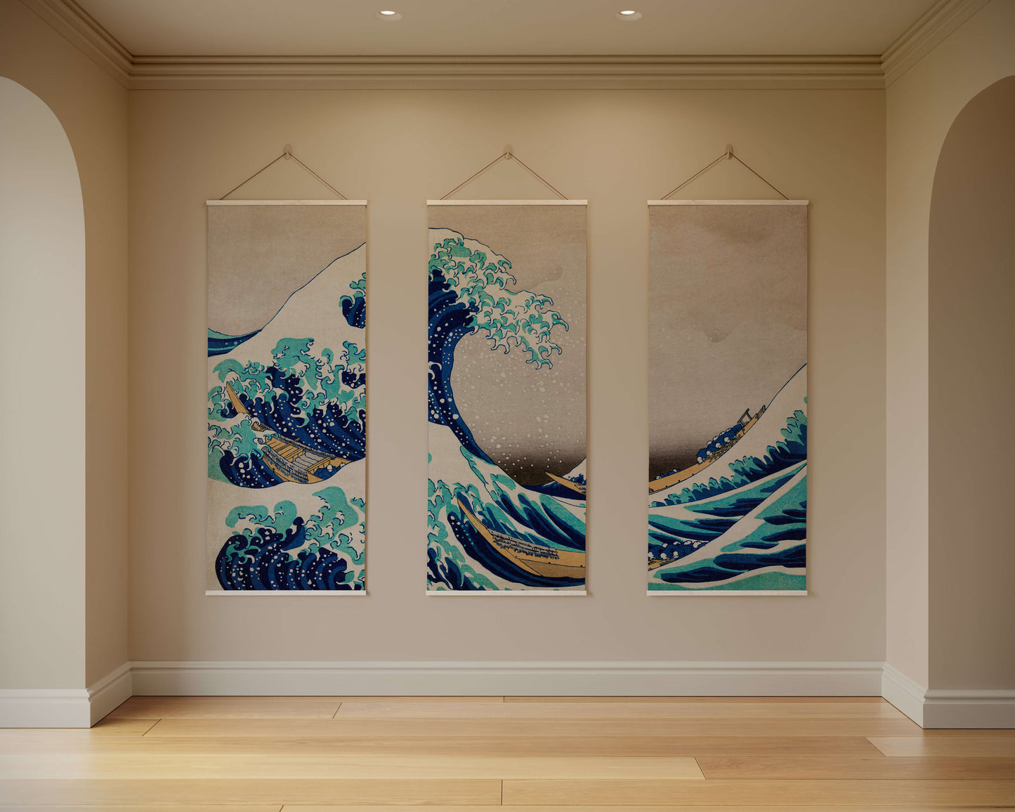 Three tapestries depicting waves hanging on a wall.
