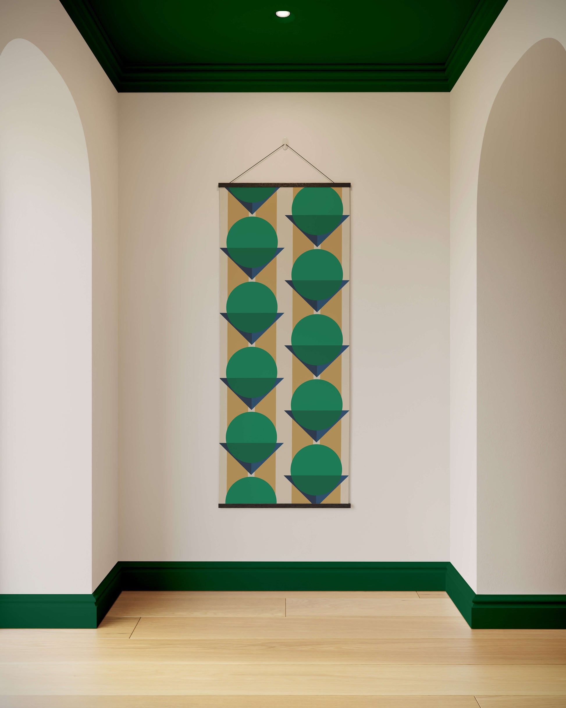 Geometric patterned tapestry hanging on a wall with green accents
