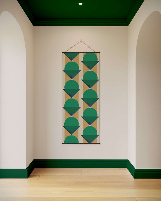 Geometric patterned tapestry hanging on a wall with green accents